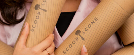 Hands holding cylindrical bamboo or cardboard tubes with 