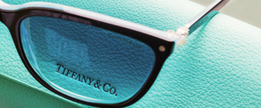 Tiffany & Co. designer eyeglasses resting on signature robin's egg blue leather packaging box