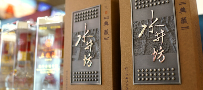 Chinese spirits liquor bottles in premium gift boxes with embossed metallic panels and traditional calligraphy
