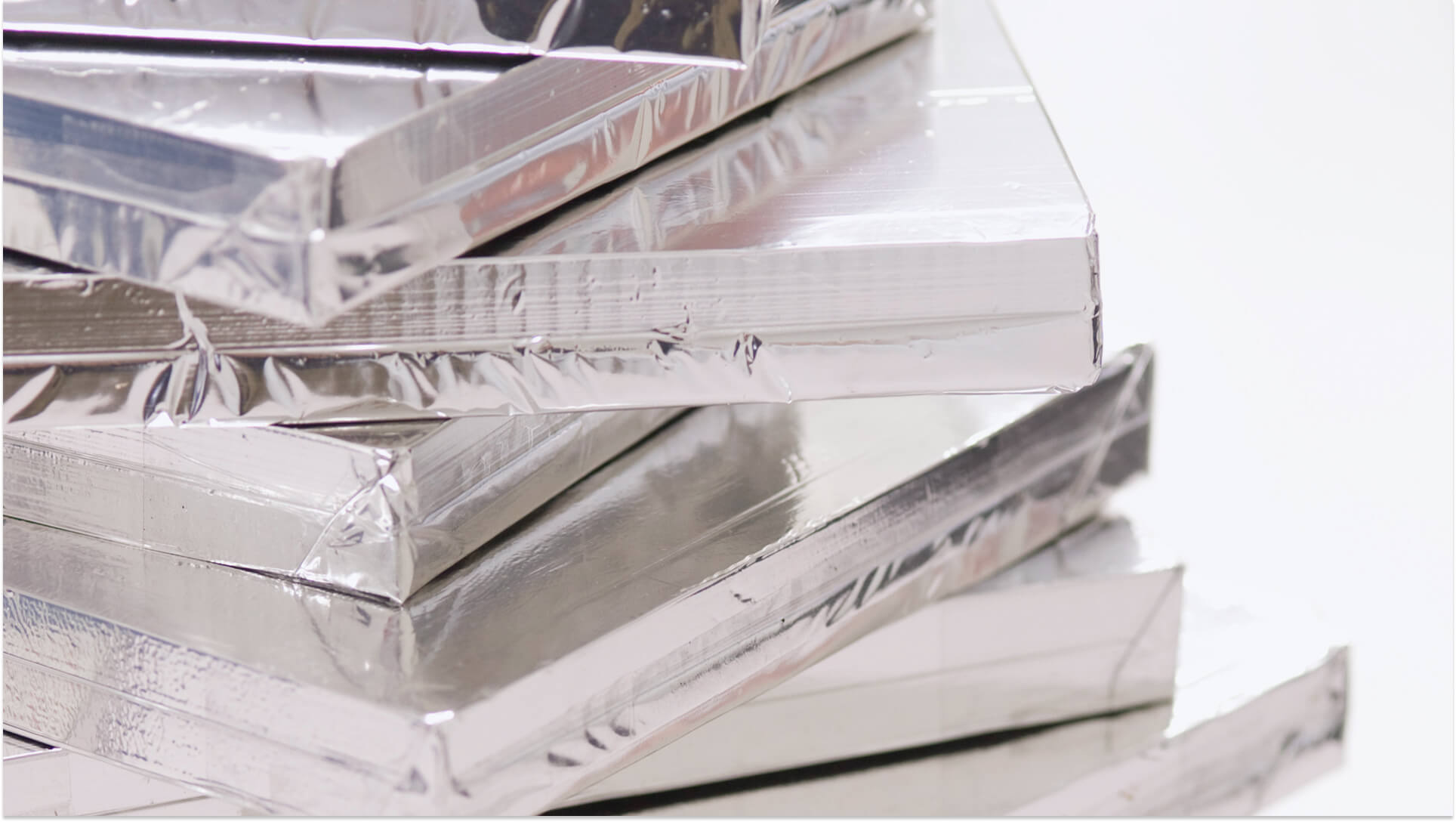 Stack of shrink-wrapped aluminum metal sheets or panels for industrial packaging materials